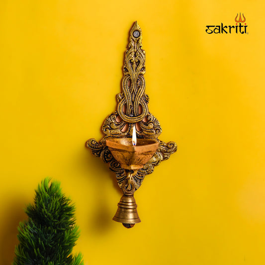 Sacred Needs Brass Wall Mount Deepam with Bell – 9.1 Inch (23.1 cm) Height | Traditional Brass Diya Wall Hanging for Pooja Room & Temple