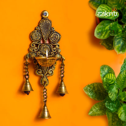 Sacred Needs Brass Wall Mount Deepam with Bell – 10.1 Inch (25.7 cm) Height | Traditional Brass Diya Wall Hanging for Pooja Room & Temple