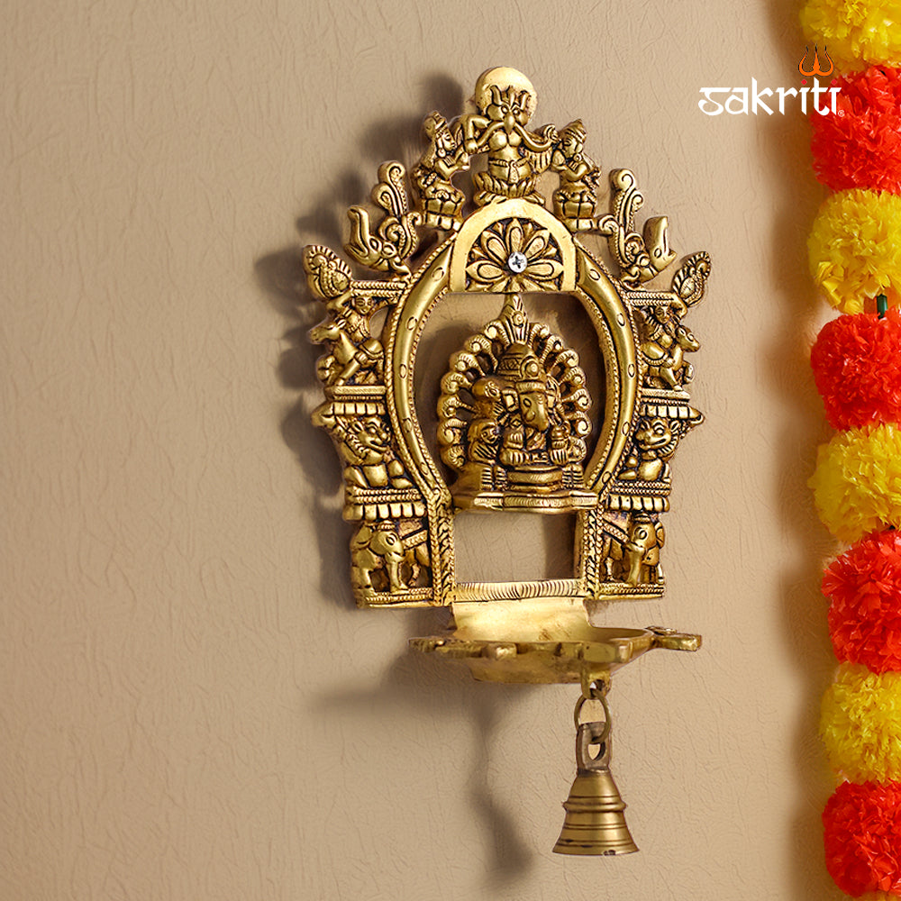 Sacred Needs Brass Wall Mounted Ganesh Deepam with Frame – 11 Inch (27.9 cm) Height | Ganesha Oil Lamp Wall Hanging for Pooja Room & Temple