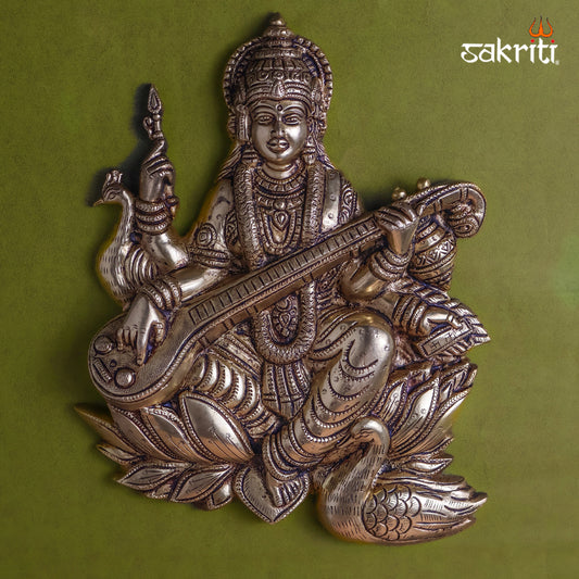 Sacred Needs Brass Saraswathi Wall Mount – 11 Inch (27.9 cm) Height | Goddess Saraswathi with Lotus & Swan Brass Wall Hanging for Pooja Room & Home Décor
