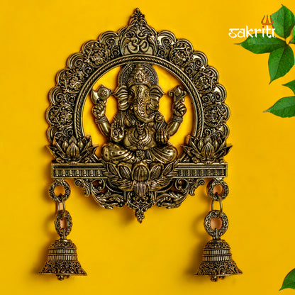 Sacred Needs Brass WC Ganesha Wall Mount with Frame & Bell – 6.4 Inch (16.3 cm) Height | Decorative Ganesha Wall Hanging for Pooja Room & Entrance