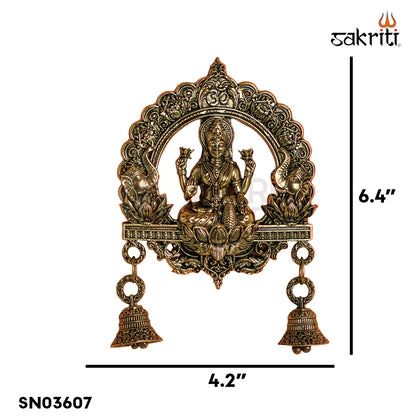 Sacred Needs Brass WC Lakshmi Wall Mount with Frame & Bell – 6.4 Inch (16.3 cm) Height | Decorative Lakshmi Wall Hanging for Pooja Room & Entrance