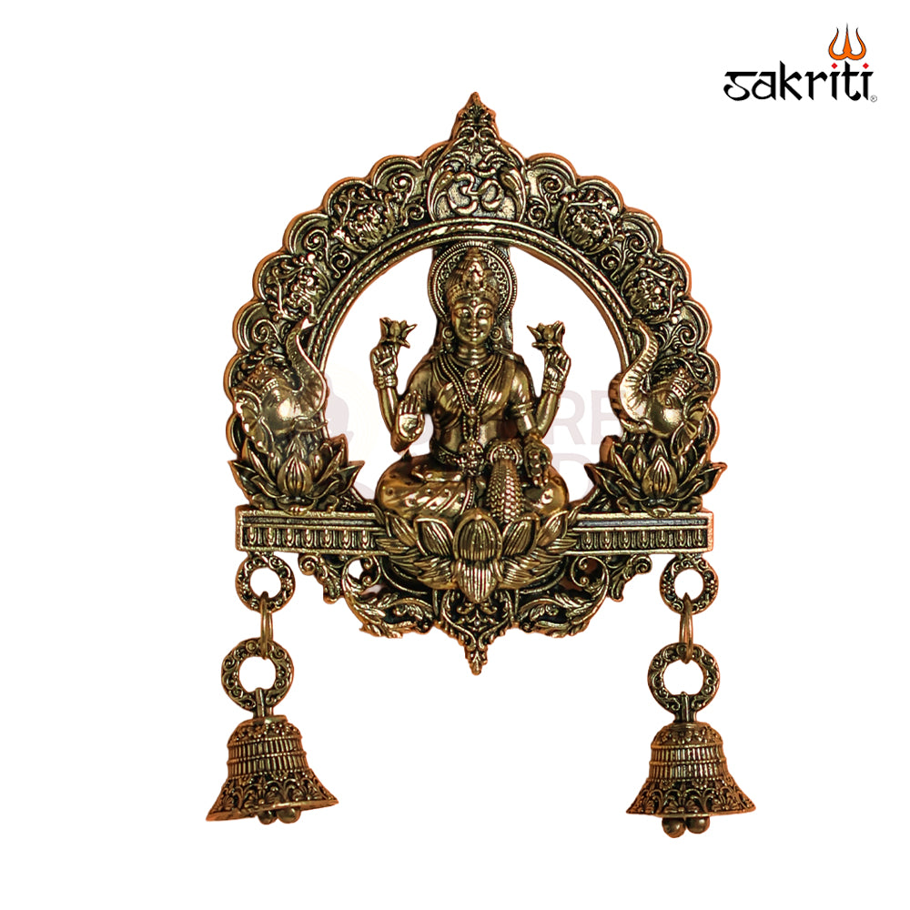 Sacred Needs Brass WC Lakshmi Wall Mount with Frame & Bell – 6.4 Inch (16.3 cm) Height | Decorative Lakshmi Wall Hanging for Pooja Room & Entrance