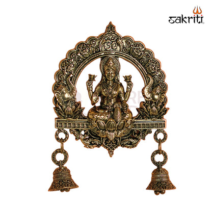 Sacred Needs Brass WC Lakshmi Wall Mount with Frame & Bell – 6.4 Inch (16.3 cm) Height | Decorative Lakshmi Wall Hanging for Pooja Room & Entrance