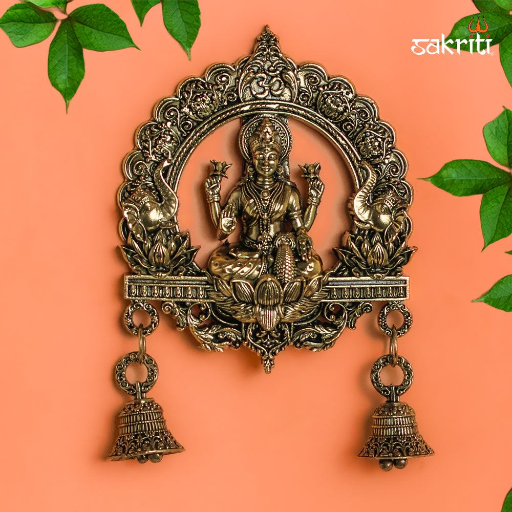 Sacred Needs Brass WC Lakshmi Wall Mount with Frame & Bell – 6.4 Inch (16.3 cm) Height | Decorative Lakshmi Wall Hanging for Pooja Room & Entrance