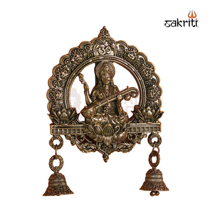 Sacred Needs Brass Saraswathi Wall Mount with Frame & Bell – 6.4 Inch (16.3 cm) Height | Goddess Saraswathi Wall Hanging for Pooja Room & Home Décor