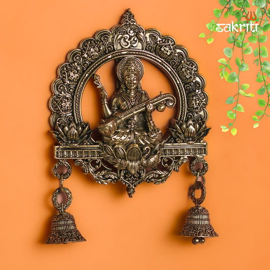Sacred Needs Brass Saraswathi Wall Mount with Frame & Bell – 6.4 Inch (16.3 cm) Height | Goddess Saraswathi Wall Hanging for Pooja Room & Home Décor